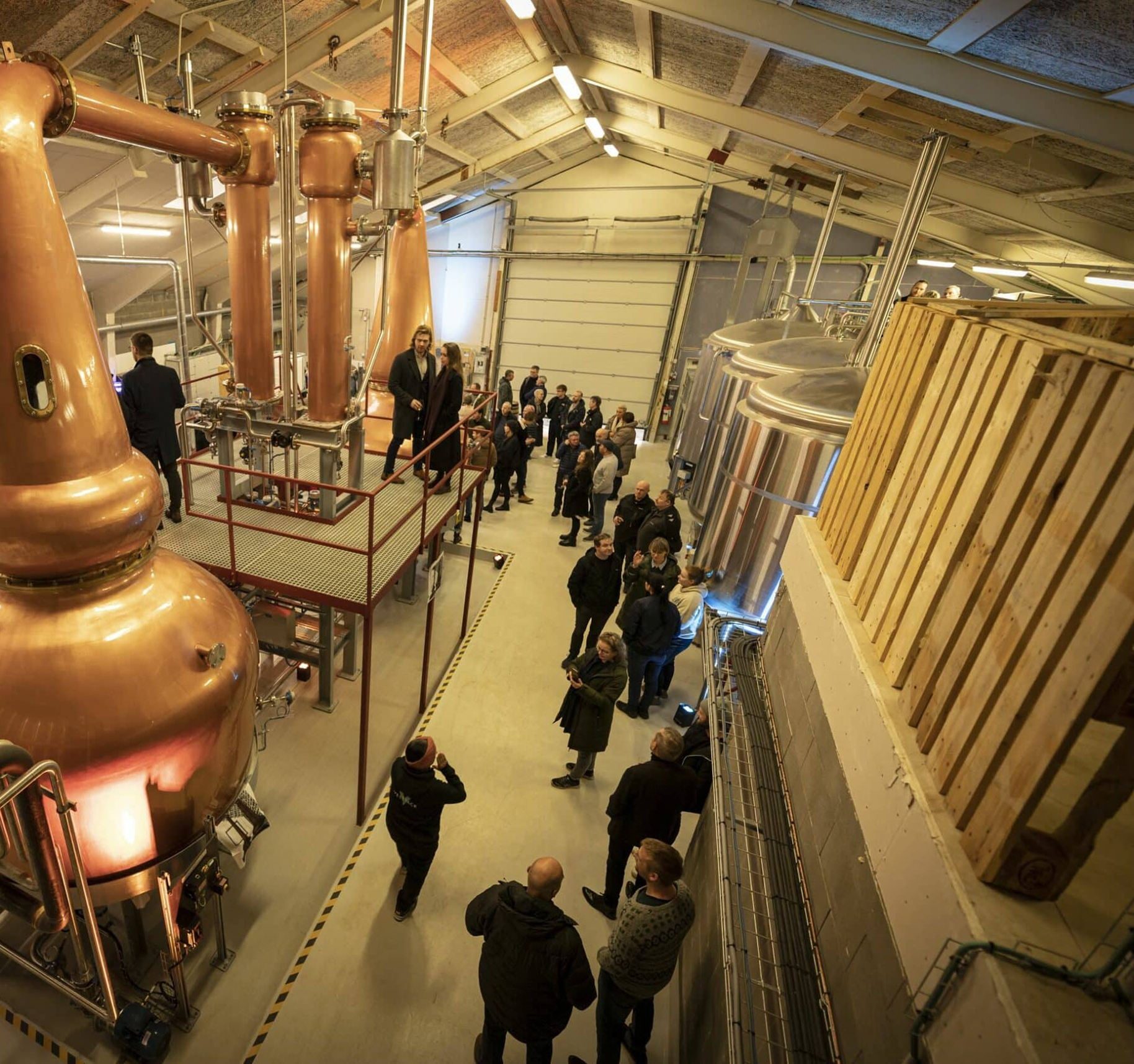 People gathered inside a distillery